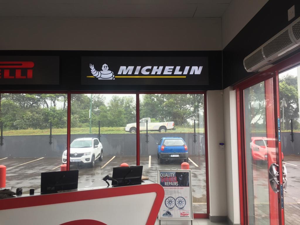 Team installing LED signage on storefront