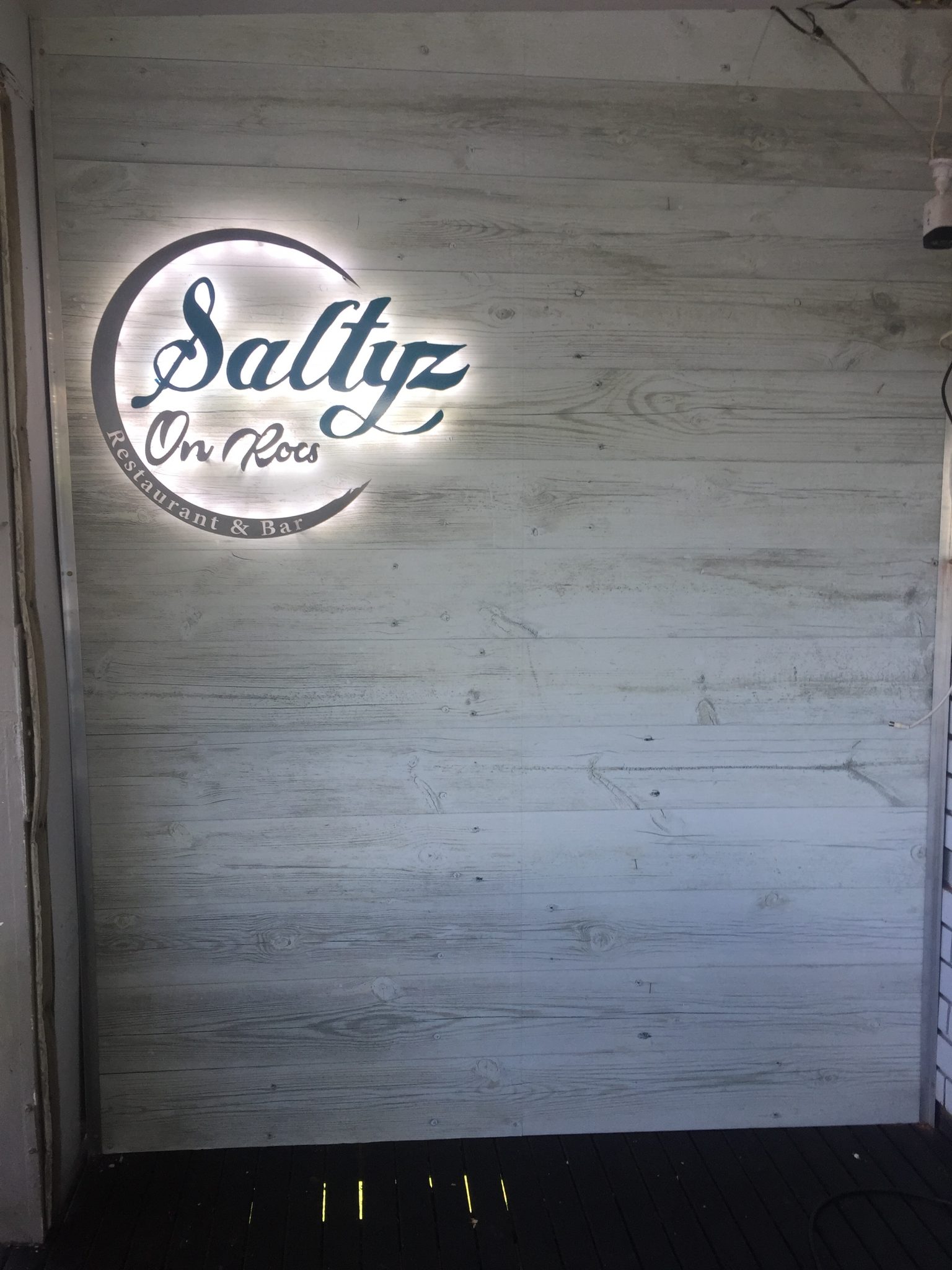 Team installing LED signage on storefront